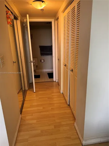 a bathroom with a toilet and a shower curtain