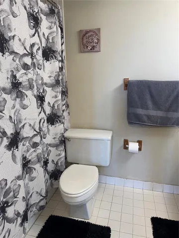 a bathroom with a toilet a sink and vanity