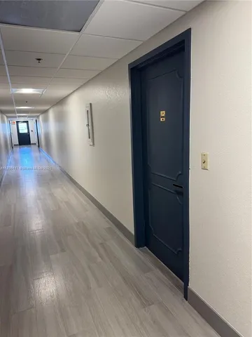 a view of gallery with wooden floor