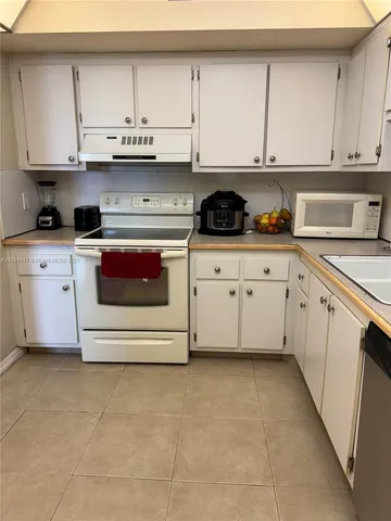 a living room with furniture and chandelier