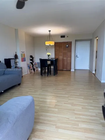 a living room with furniture window and wooden floor