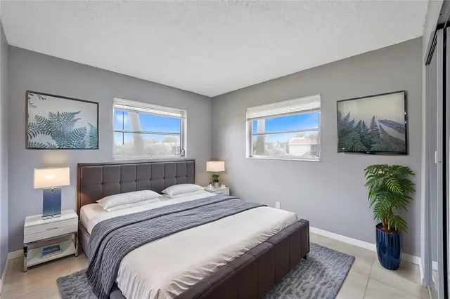 a bedroom with a bed and a painting on the wall