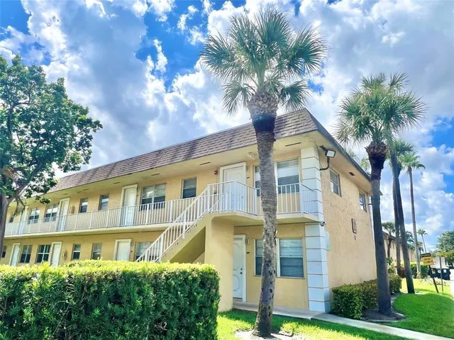 a view of a backyard with table and chairs under an umbrella