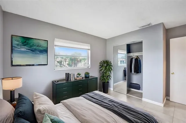 a bedroom with a bed and a dresser in it