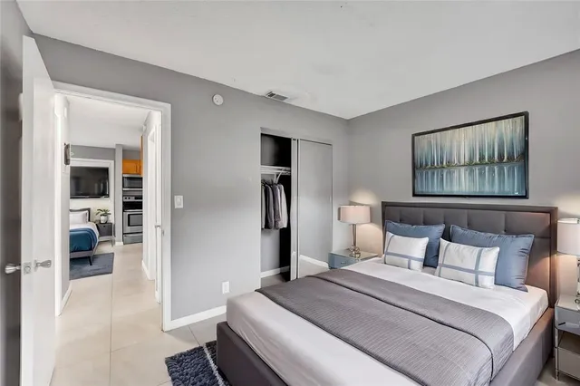 a bedroom with a bed and a painting on the wall