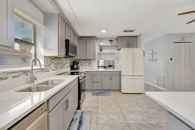 a kitchen with a sink a stove and refrigerator