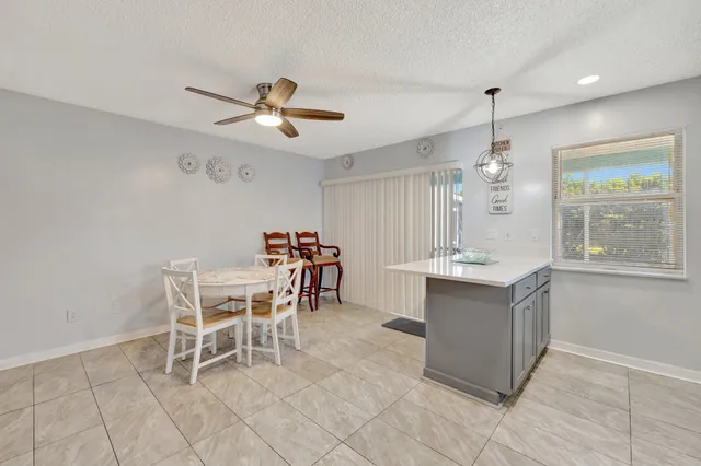 a view of a kitchen with a dining table chairs and cabinets