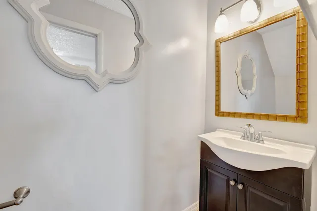 a bathroom with a sink vanity and a mirror
