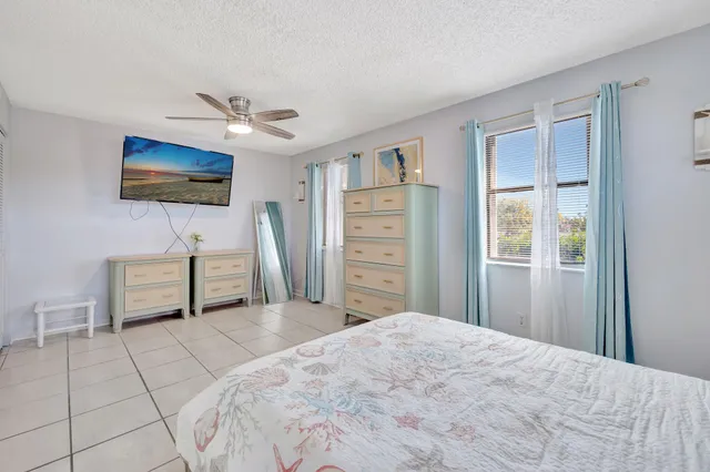 a bedroom with furniture and a flat screen tv