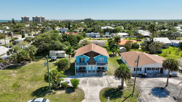 an aerial view of residential houses with outdoor space