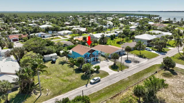 an aerial view of a houses with a swimming pool