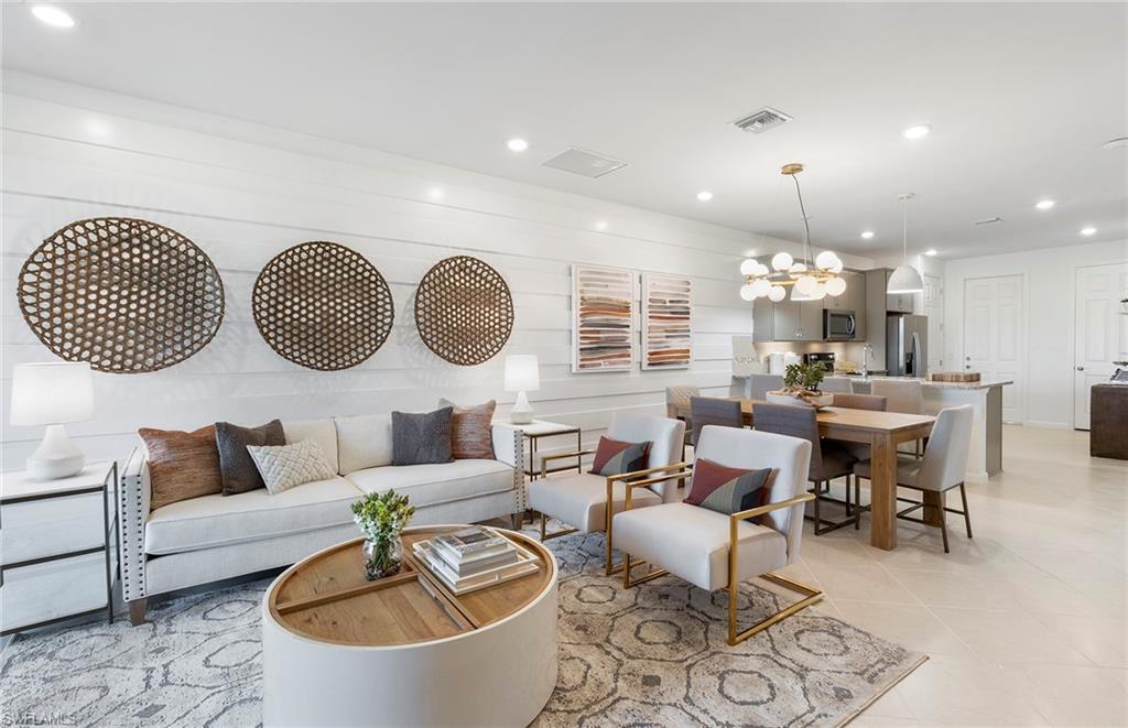 6426 Memorial Lane Ave Maria, FL 34142 - Photo 13 of 38 a living room with furniture kitchen view and a mirror