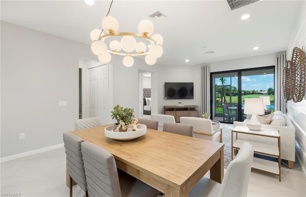 6426 Memorial Lane Ave Maria, FL 34142 - Photo 14 of 38 a living room with kitchen island furniture and a flat screen tv