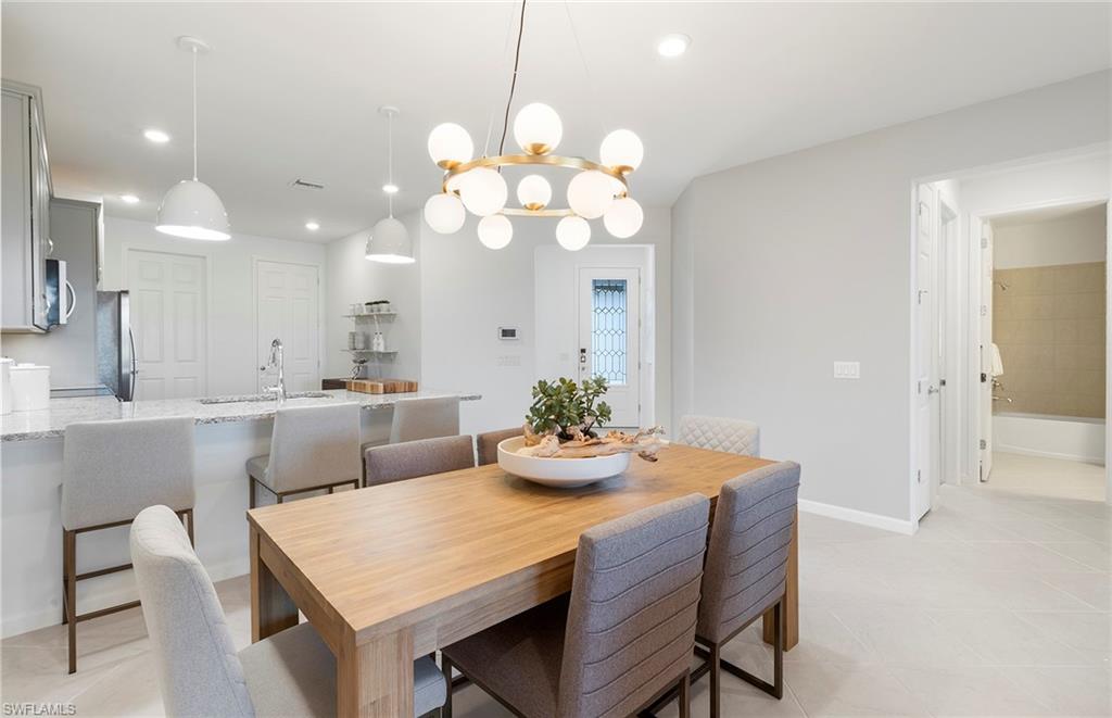 6426 Memorial Lane Ave Maria, FL 34142 - Photo 15 of 38 a dining room with furniture and chandelier