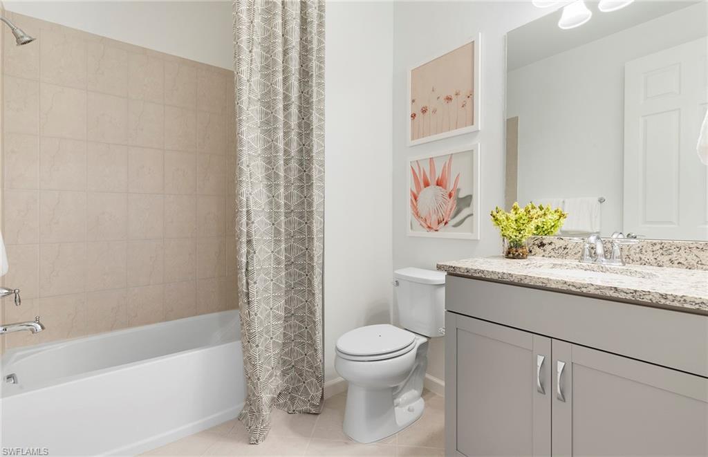 6426 Memorial Lane Ave Maria, FL 34142 - Photo 22 of 38 a bathroom with a granite countertop sink a toilet and a bathtub