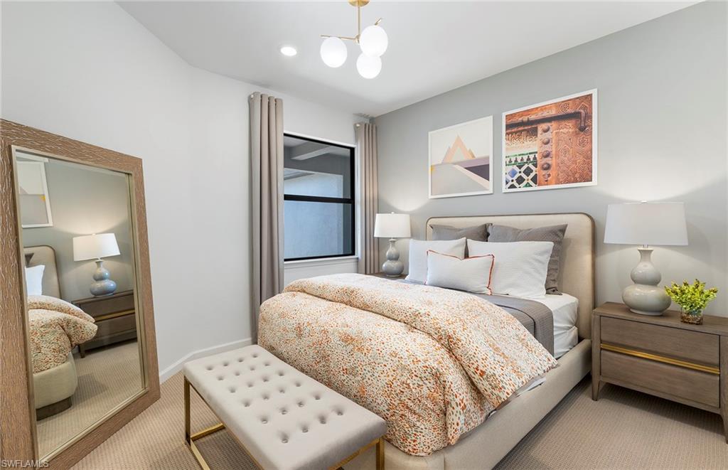 6426 Memorial Lane Ave Maria, FL 34142 - Photo 23 of 38 a bedroom with a large bed and a couch