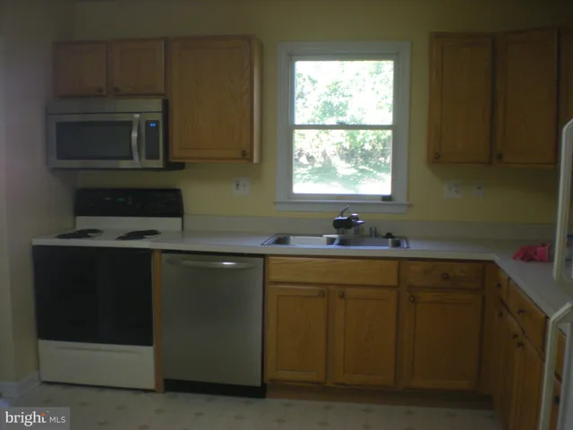 a kitchen with a refrigerator and cabinets