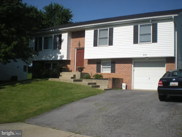 a view of house that has a car park front of house