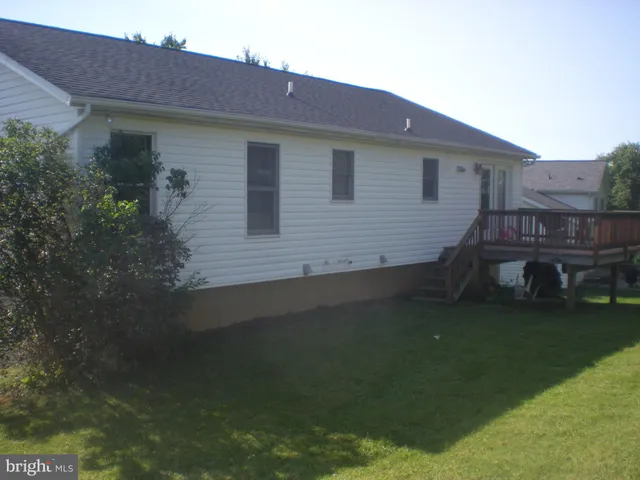 a view of house with backyard