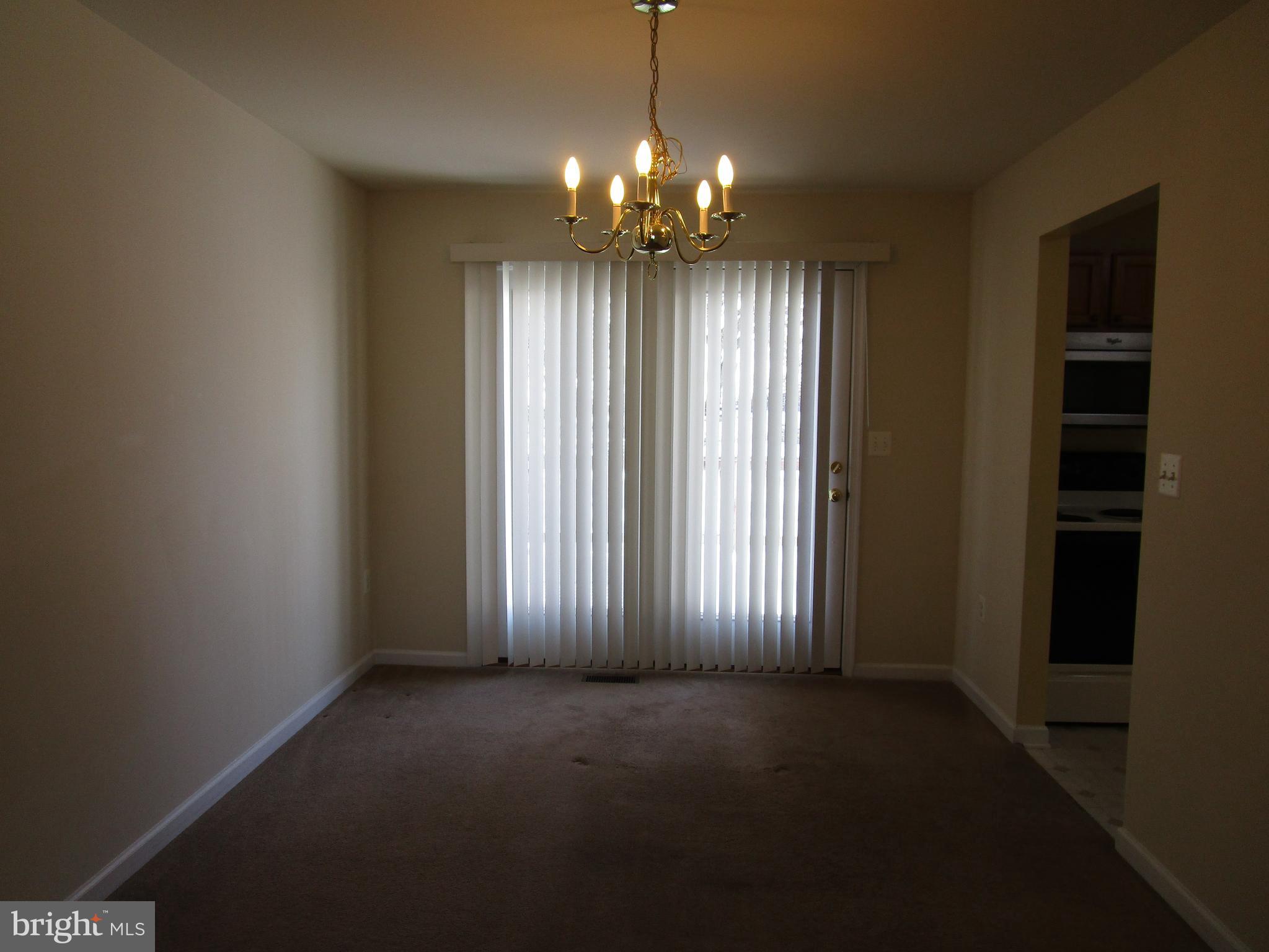 823 Snowfall Way Westminster, MD 21157 - Photo 10 of 23 an empty room with windows and chandelier fan