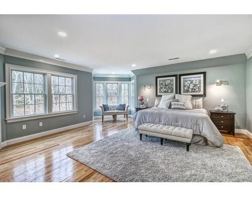 10 Russell Road Lexington, MA 02420 - Photo 20 of 29 a spacious bedroom with a large bed a chandelier and windows