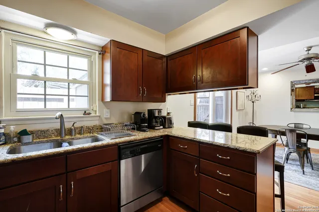 a kitchen with a sink window and cabinets