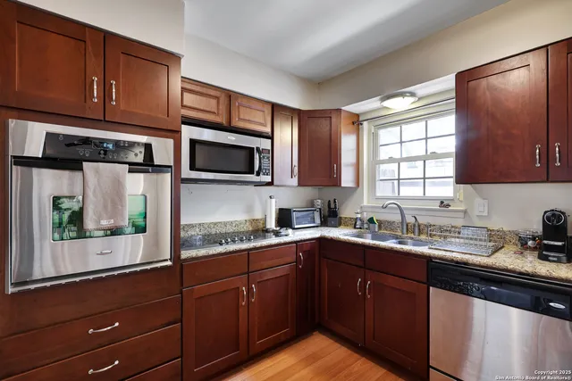 a kitchen with a sink a window and appliances