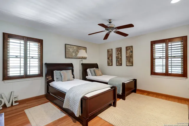 a bedroom with two beds and a window