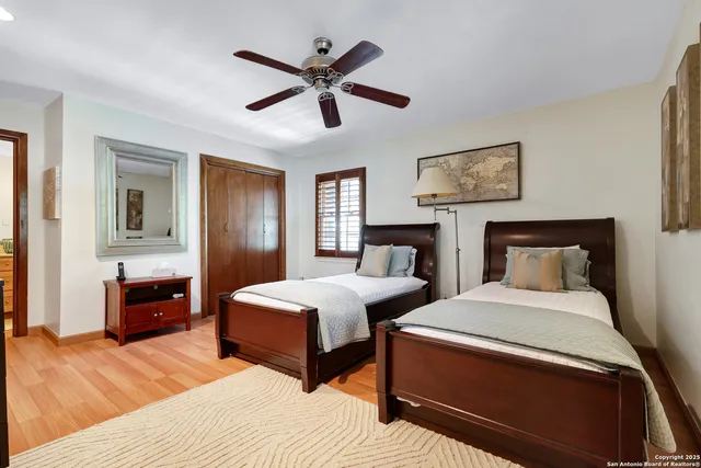 a bedroom with two beds and a chandelier