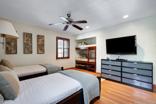 a bedroom with two beds and a flat screen tv