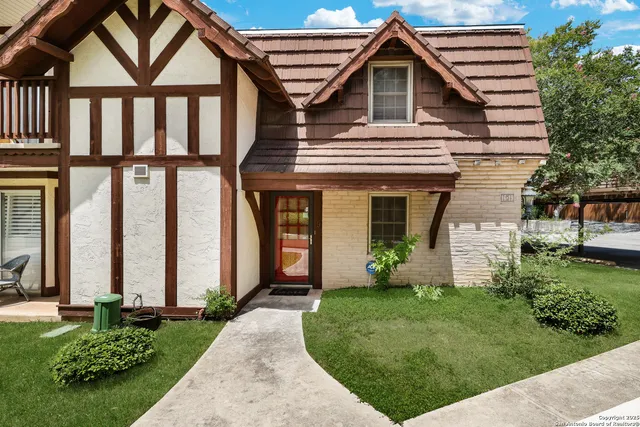 a front view of a house with a yard and porch