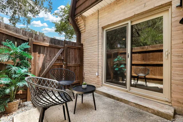 a view of balcony with wooden floor and outdoor seating