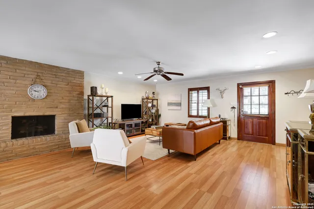 a living room with furniture a fireplace and a flat screen tv