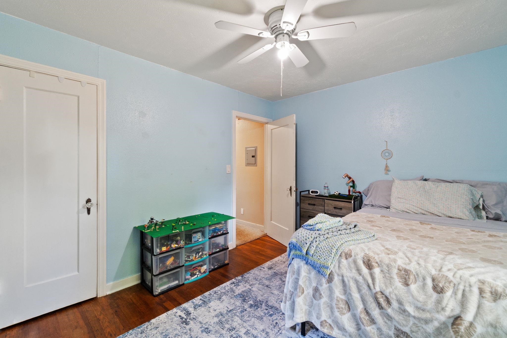 355 Jackson Street Red Bluff, CA 96080 - Photo 13 of 24 a bedroom with a bed and a chandelier