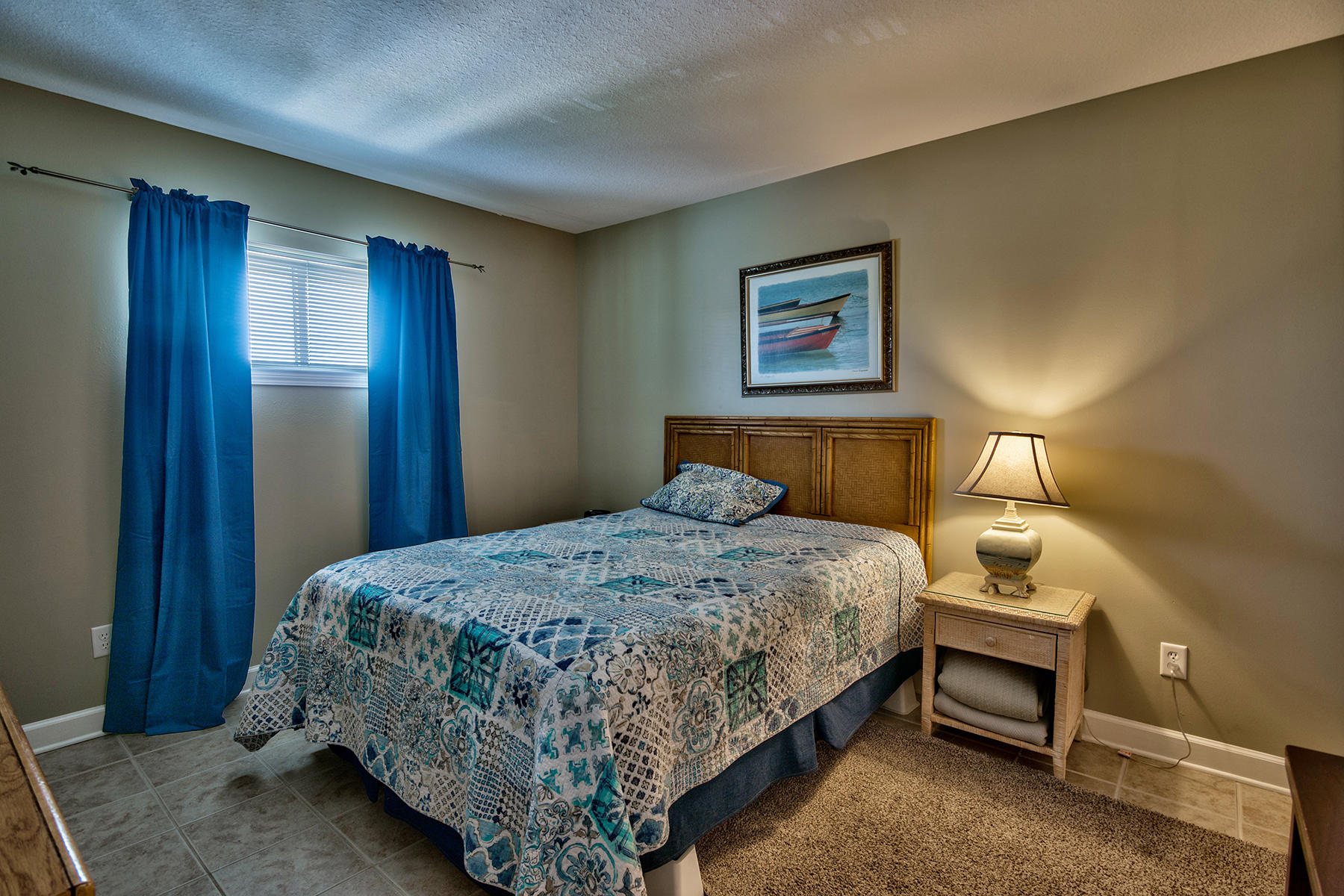 595 Eastern Lake Road, Unit 108 Santa Rosa Beach, FL 32459 - Photo 13 of 26 a bedroom with a bed and lamp