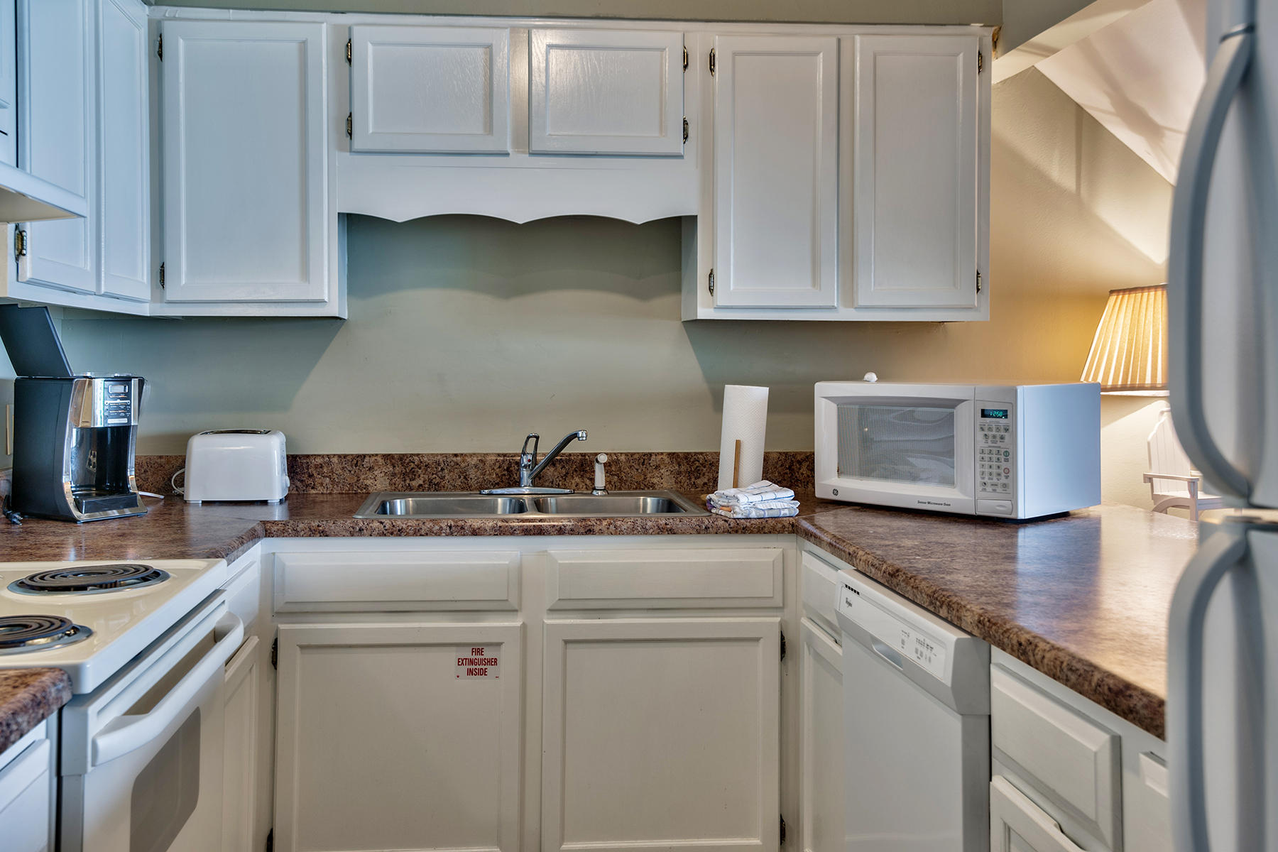 595 Eastern Lake Road, Unit 108 Santa Rosa Beach, FL 32459 - Photo 9 of 26 a kitchen with stainless steel appliances granite countertop a sink stove and cabinets