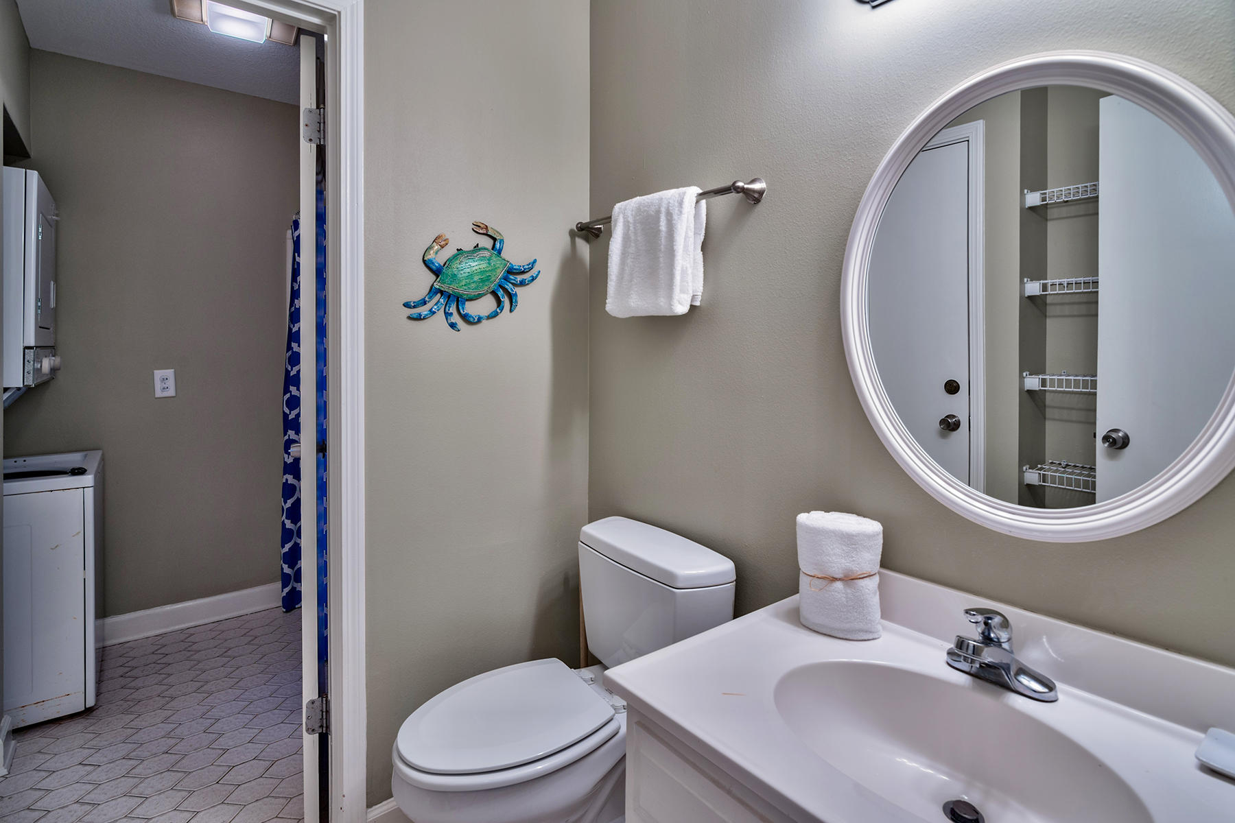 595 Eastern Lake Road, Unit 108 Santa Rosa Beach, FL 32459 - Photo 10 of 26 a bathroom with a sink mirror and toilet