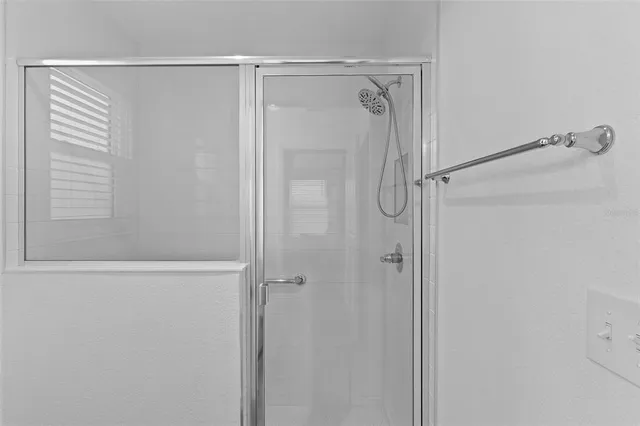 a bathroom with a glass shower door