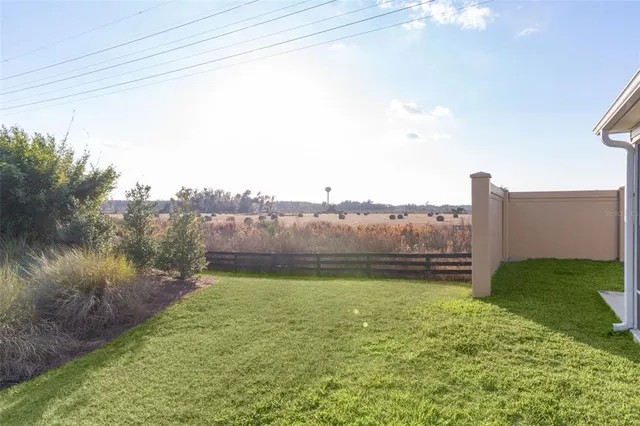 a view of a backyard with plants and lake view
