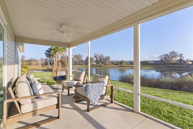 a living room with patio furniture and garden