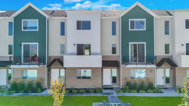 493 East Alice Way Layton, UT 84041 - Photo 2 of 31 View of front facade featuring a balcony, brick siding, and a front lawn
