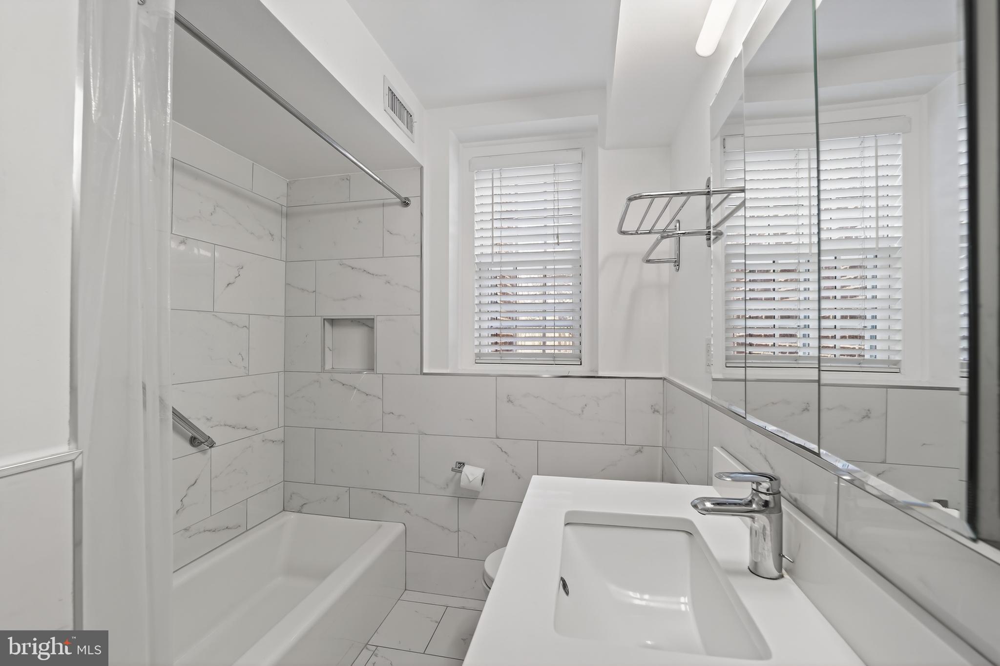 3450 39th Street Northwest, Unit A685 Washington, DC 20016 - Photo 13 of 30 a bathroom with sink and bathtub