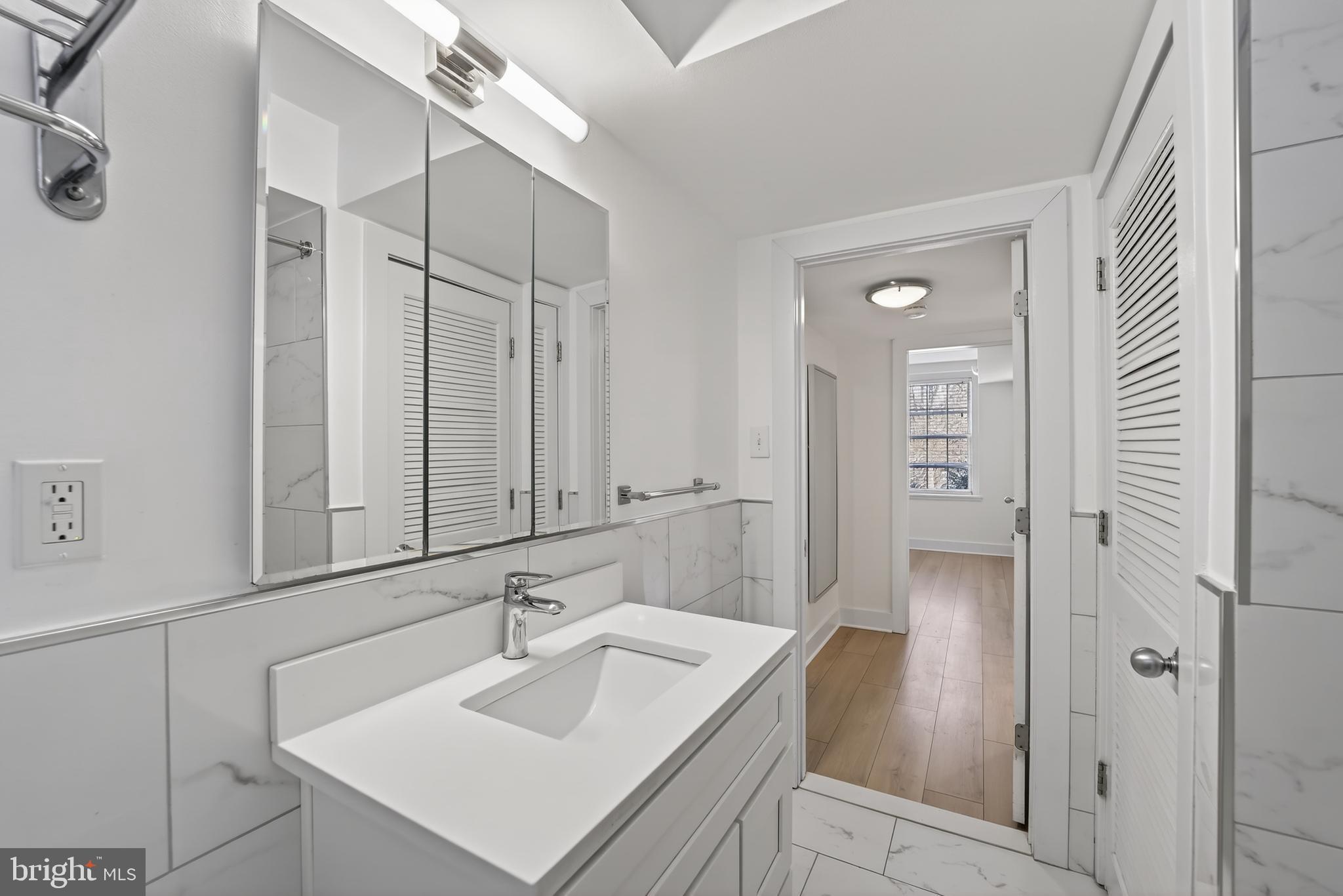 3450 39th Street Northwest, Unit A685 Washington, DC 20016 - Photo 14 of 30 a bathroom with a sink and a mirror