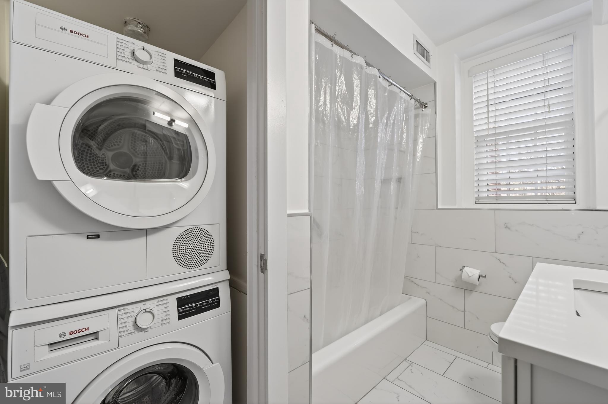 3450 39th Street Northwest, Unit A685 Washington, DC 20016 - Photo 15 of 30 a view of a bathroom with washing machine and washing machine