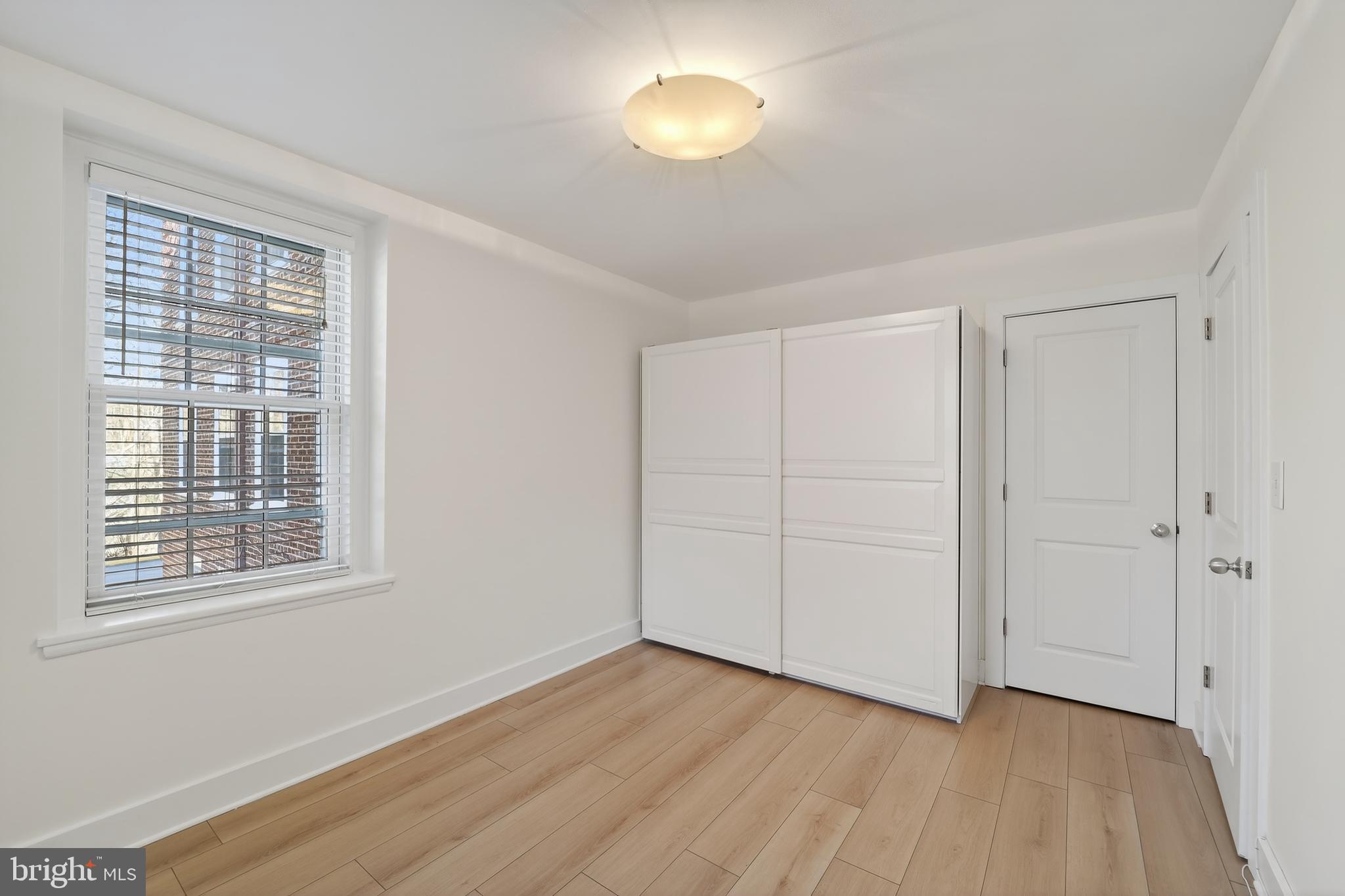 3450 39th Street Northwest, Unit A685 Washington, DC 20016 - Photo 16 of 30 a view of an empty room with wooden floor and a window