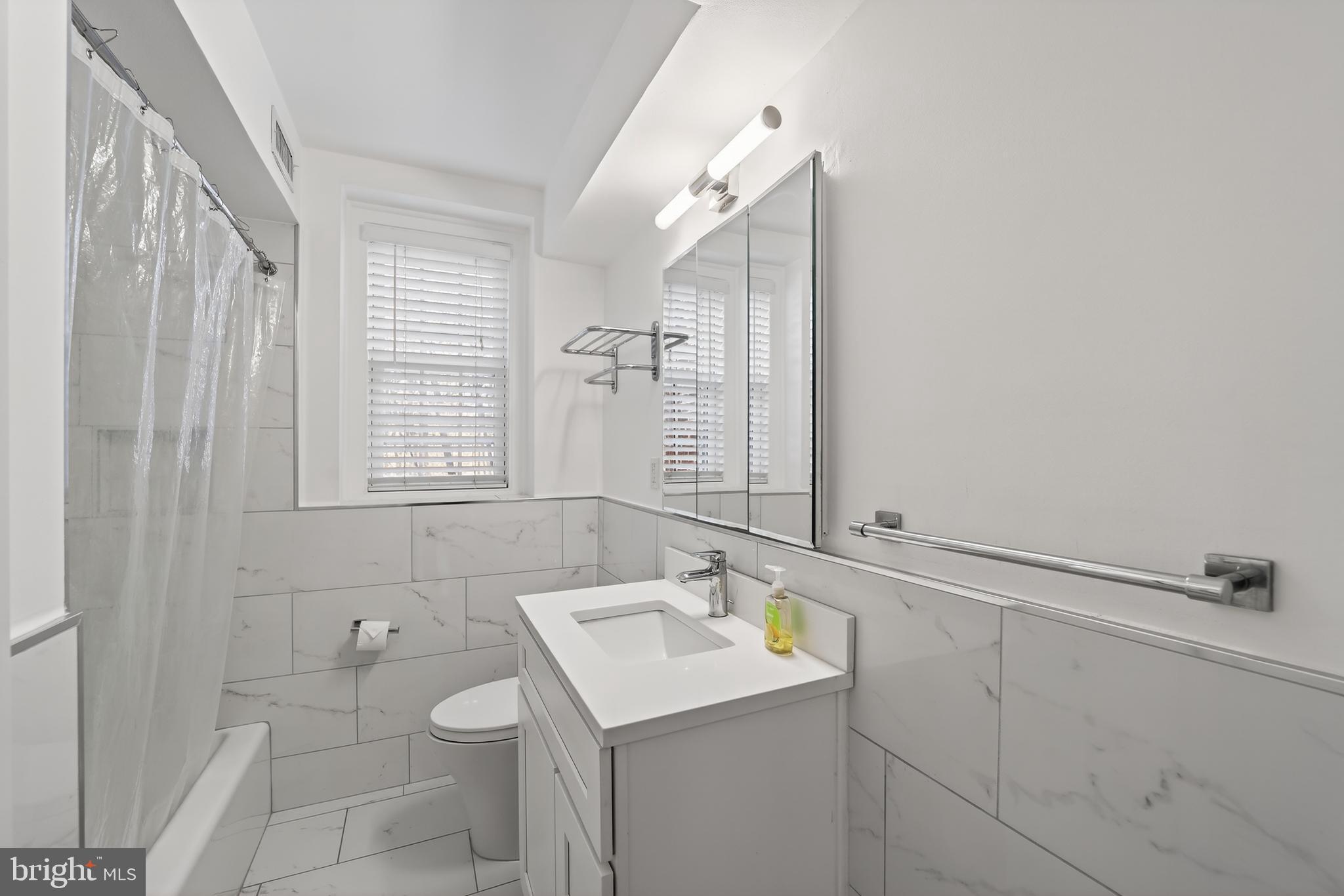 3450 39th Street Northwest, Unit A685 Washington, DC 20016 - Photo 18 of 30 a bathroom with a sink toilet and vanity
