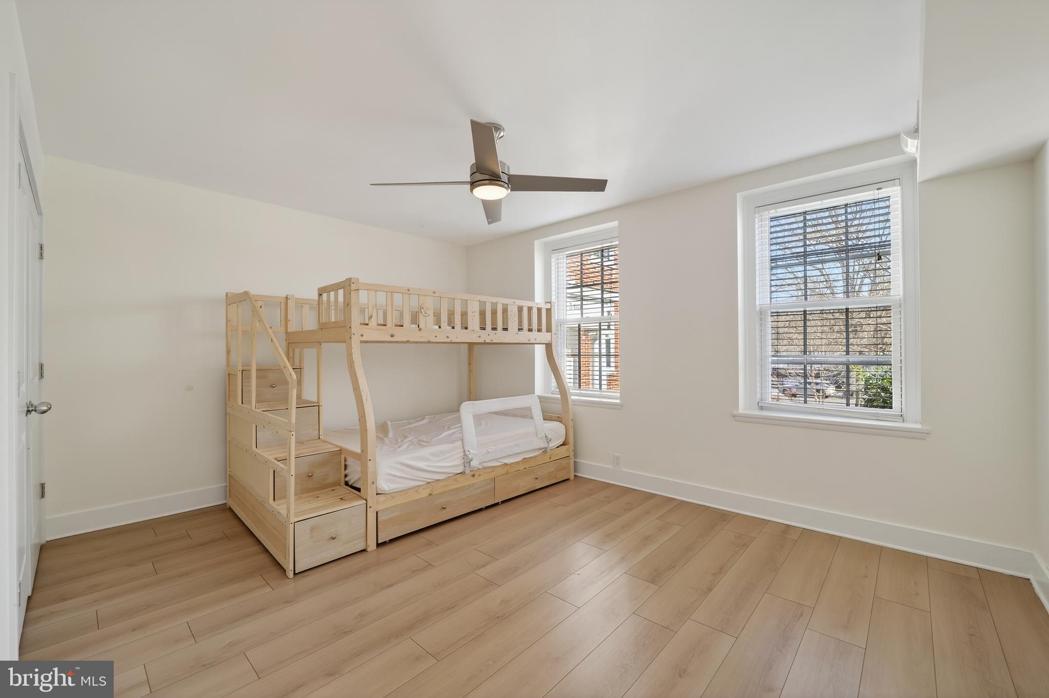 3450 39th Street Northwest, Unit A685 Washington, DC 20016 - Photo 22 of 30 an empty room with wooden floor fan and windows
