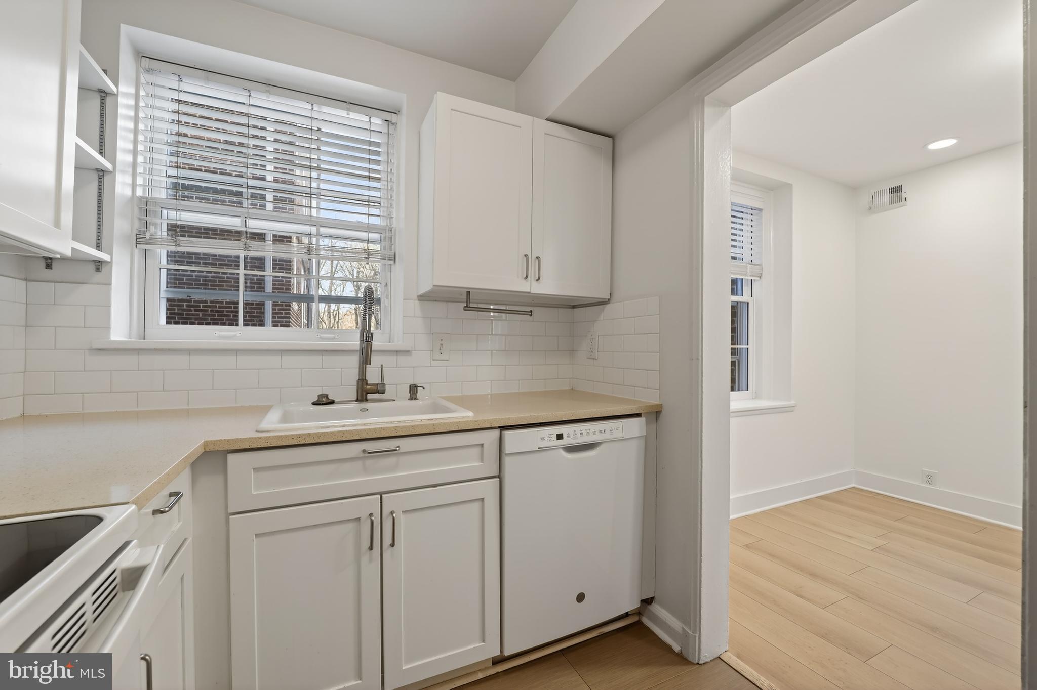 3450 39th Street Northwest, Unit A685 Washington, DC 20016 - Photo 26 of 30 a kitchen with white cabinets and a sink