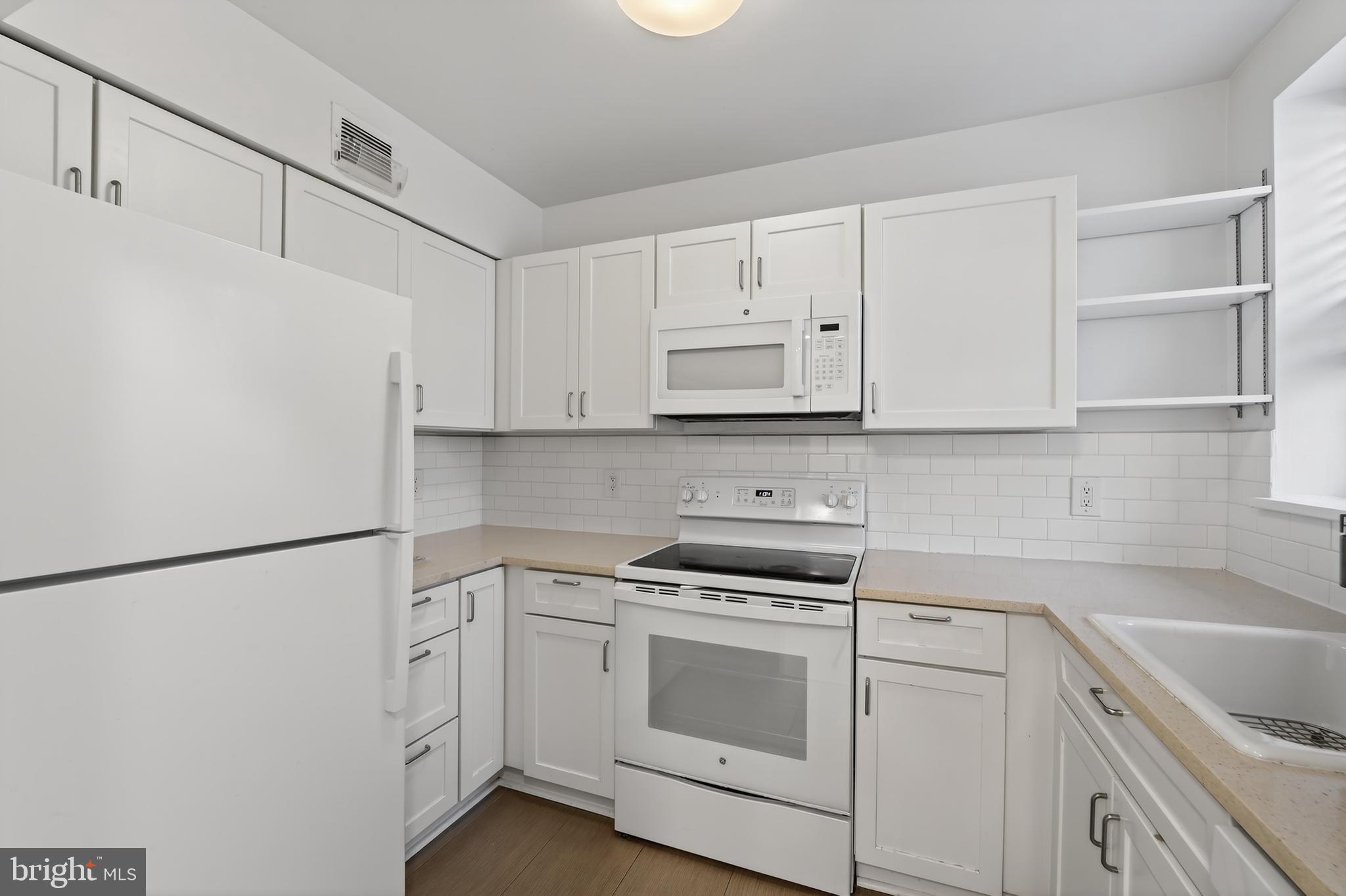 3450 39th Street Northwest, Unit A685 Washington, DC 20016 - Photo 8 of 30 a kitchen with cabinets appliances a sink and a counter top