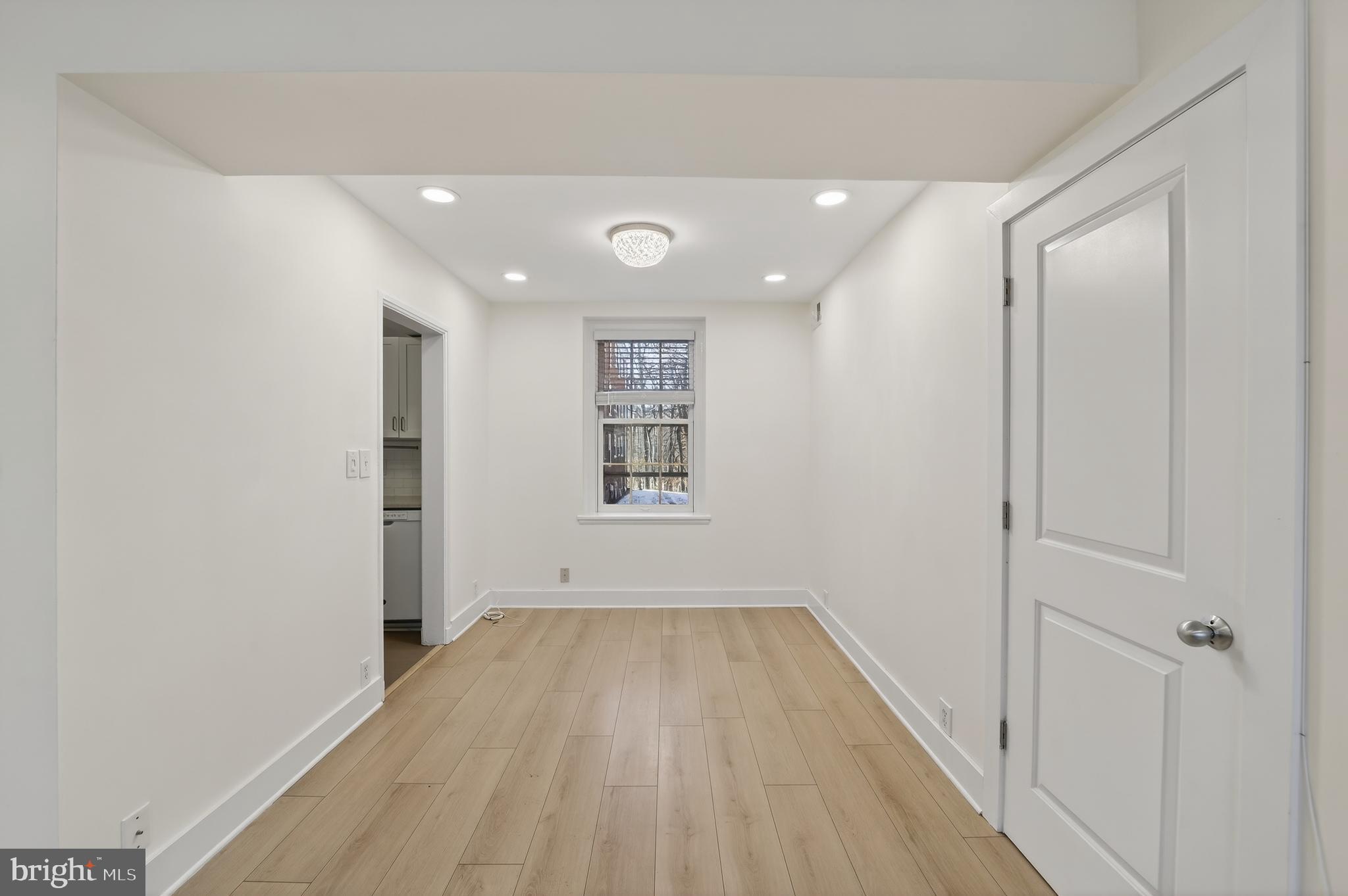 3450 39th Street Northwest, Unit A685 Washington, DC 20016 - Photo 9 of 30 a view of a hallway with wooden floor and a bathroom